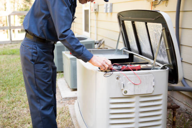 Senior Adult air conditioner Technician/Electrician  services outdoor AC unit and the Gas Generator.  He checks the interior of the generator.